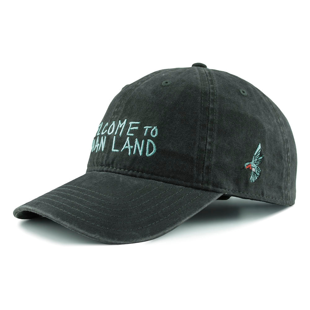 Black cap with 'Welcome to Indian Land' embroidered text in blue and colorful hummingbird Urban Native era logo