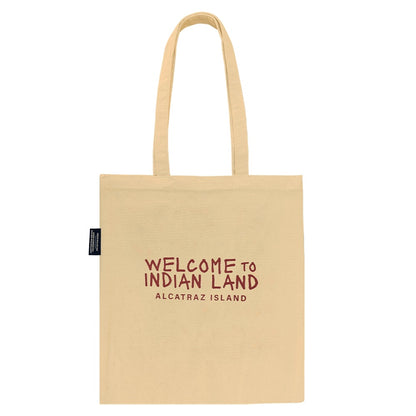 Beige tote bag with red text and Alcatraz Occupation political statements on a white background